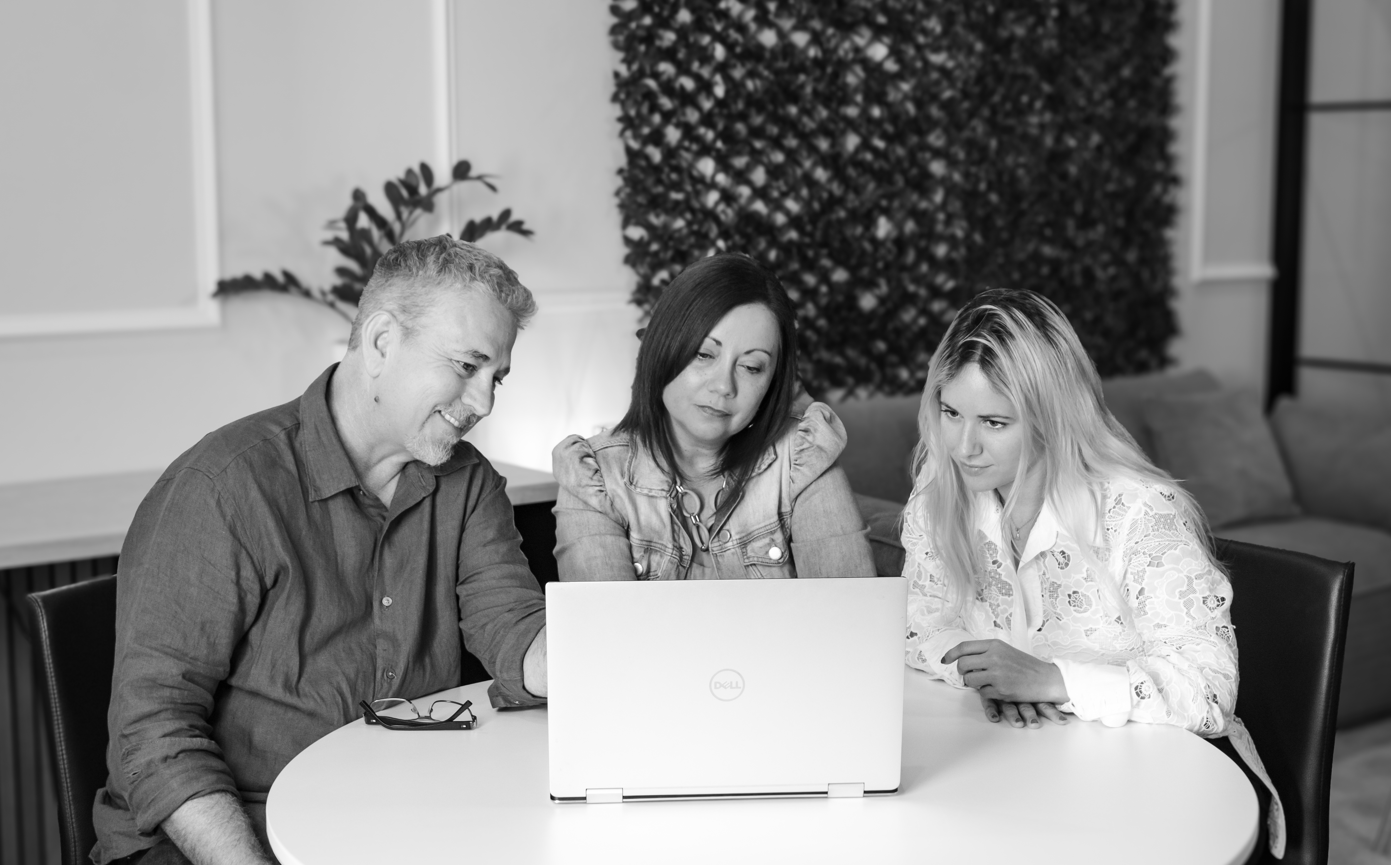 Gold Coast Marketing Agency team around a laptop
